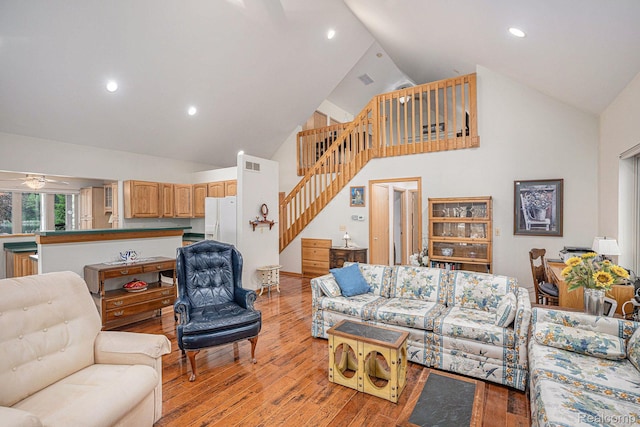 5793 Gark Rd, Attica, MI 48412 - living room featuring high vaulted ceiling, ceiling fan, stairway, light wood-type flooring, and recessed lighting