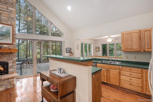 5793 Gark Rd, Attica, MI 48412 - kitchen with a sink, high vaulted ceiling, light wood-type flooring, dark countertops, and a kitchen island