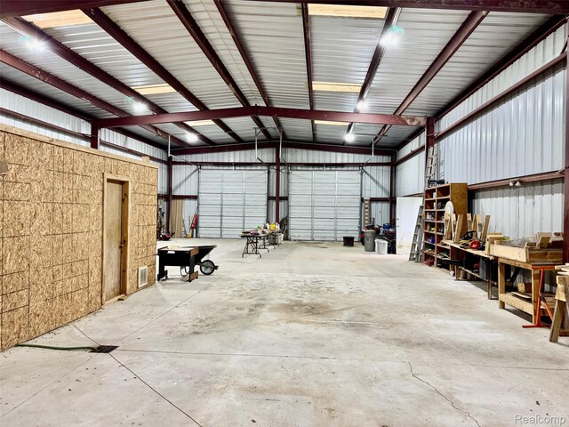 5793 Gark Rd, Attica, MI 48412 - garage with metal wall and a workshop area