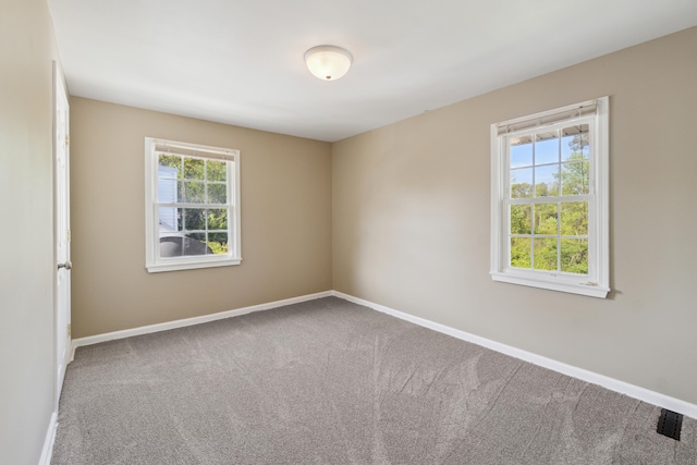 empty room with carpet and baseboards