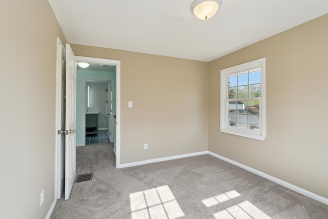 unfurnished bedroom featuring carpet flooring and baseboards