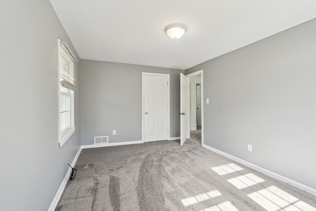 unfurnished bedroom featuring baseboards and carpet flooring