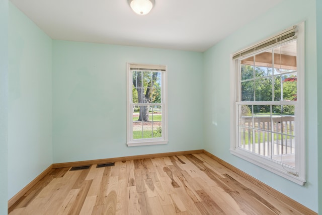empty room with light wood-style flooring and baseboards