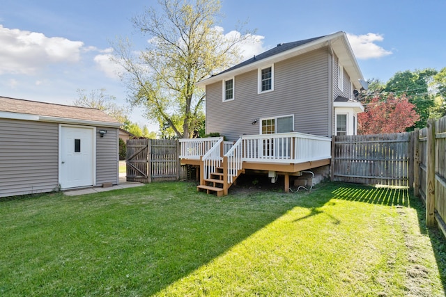 back of house featuring a wooden deck and a gate