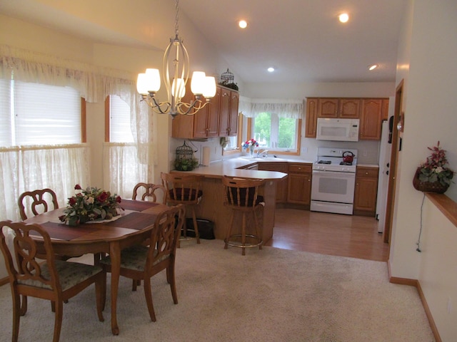 2625 Rolling Ridge Ln NW, Grand Rapids, MI 49534 - dining space featuring a chandelier, light carpet, recessed lighting, and baseboards
