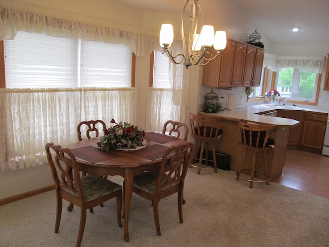 2625 Rolling Ridge Ln NW, Grand Rapids, MI 49534 - dining area featuring a chandelier and light colored carpet