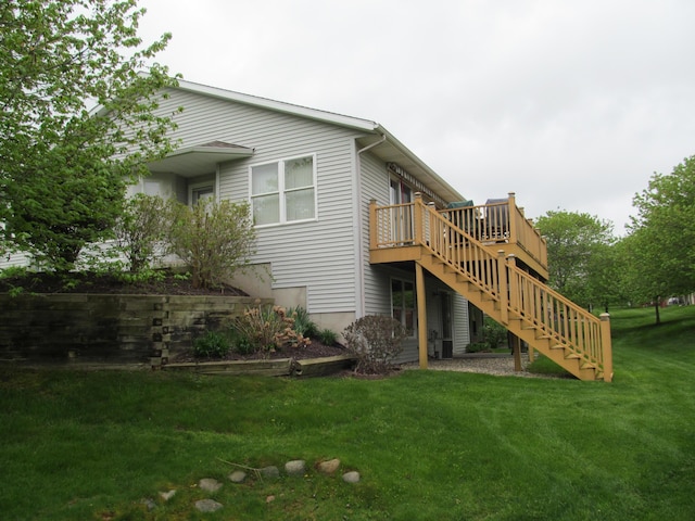 2625 Rolling Ridge Ln NW, Grand Rapids, MI 49534 - rear view of property featuring stairs, a deck, and a yard