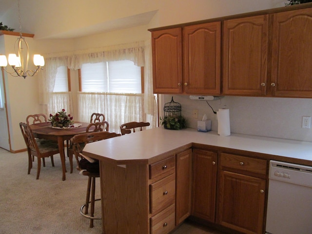 2625 Rolling Ridge Ln NW, Grand Rapids, MI 49534 - kitchen featuring white dishwasher, a chandelier, light countertops, and brown cabinets