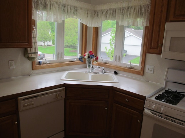 2625 Rolling Ridge Ln NW, Grand Rapids, MI 49534 - kitchen featuring white appliances, a sink, and light countertops