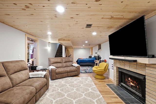 2655 Tanbark Trl, Saint Joseph, MI 49085 - living room featuring stairs, wooden ceiling, wood finished floors, recessed lighting, and a fireplace with flush hearth