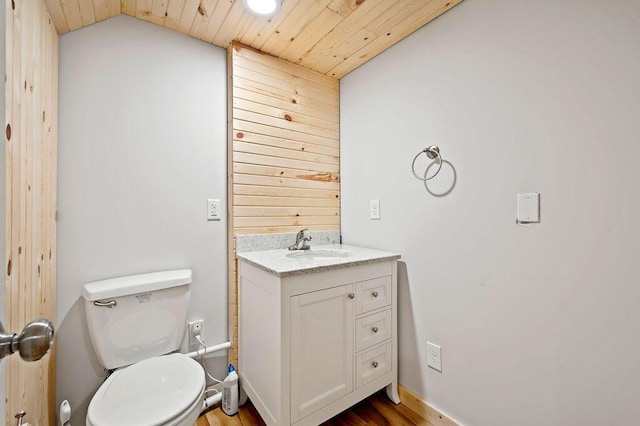 2655 Tanbark Trl, Saint Joseph, MI 49085 - bathroom with vanity, toilet, wood finished floors, wooden ceiling, and vaulted ceiling