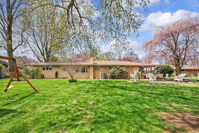 2655 Tanbark Trl, Saint Joseph, MI 49085 - rear view of house with a patio, a yard, brick siding, central AC unit, and a chimney