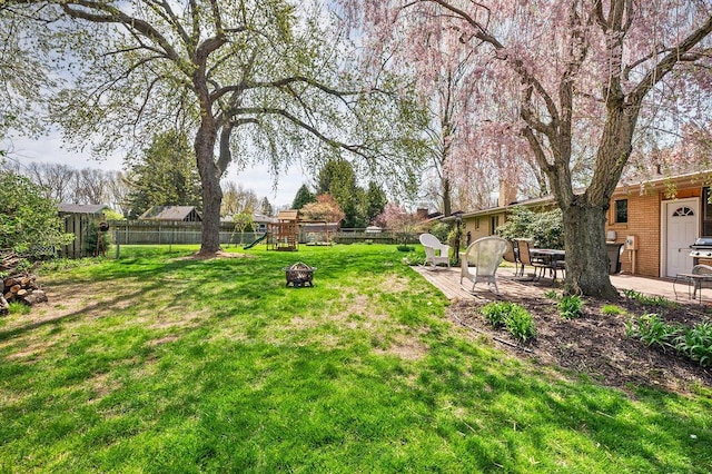 2655 Tanbark Trl, Saint Joseph, MI 49085 - view of yard featuring a playground, a patio, and a fire pit
