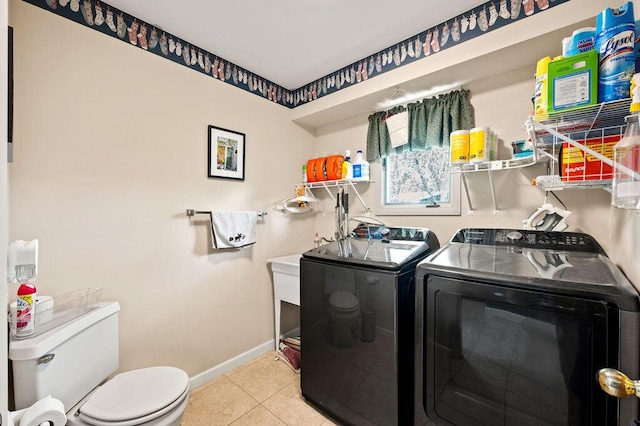 2655 Tanbark Trl, Saint Joseph, MI 49085 - laundry room featuring washer and dryer, tile patterned flooring, and baseboards