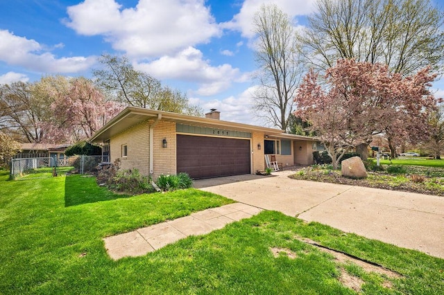 2655 Tanbark Trl, Saint Joseph, MI 49085 - ranch-style house featuring brick siding, an attached garage, a chimney, and concrete driveway