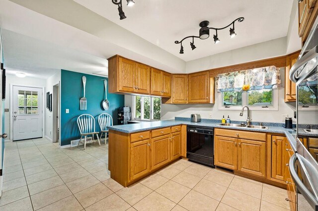 2655 Tanbark Trl, Saint Joseph, MI 49085 - kitchen with a sink, dishwasher, brown cabinets, a peninsula, and light tile patterned floors