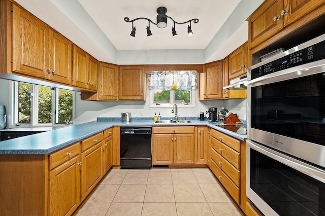 2655 Tanbark Trl, Saint Joseph, MI 49085 - kitchen with black appliances, a sink, brown cabinetry, and light tile patterned floors