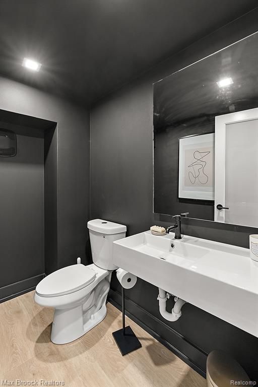 533 E Harrison Ave Unit 18, Royal Oak, MI 48067 - half bathroom featuring toilet and wood finished floors