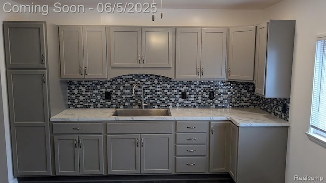 11657 Engleman Rd, Warren, MI 48089 - kitchen with gray cabinetry, a sink, decorative backsplash, and healthy amount of natural light