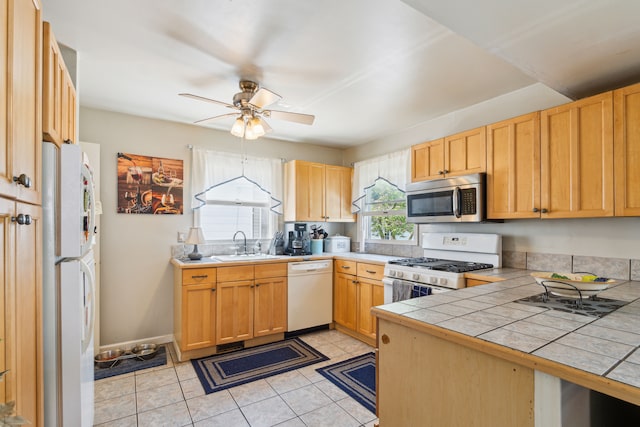 3128 Woodside St, Dearborn, MI 48124 - kitchen featuring white appliances, a sink, tile counters, a ceiling fan, and light tile patterned flooring