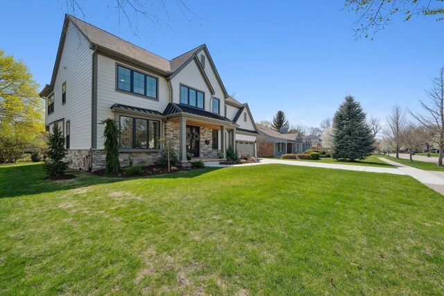 1663 Fairway Dr, Birmingham, MI 48009 - view of front of home with a standing seam roof, stone siding, a front lawn, driveway, and metal roof