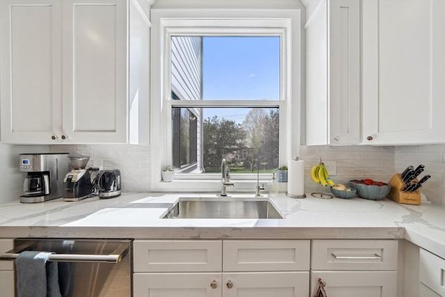 1663 Fairway Dr, Birmingham, MI 48009 - kitchen with stainless steel dishwasher, a sink, white cabinetry, and backsplash