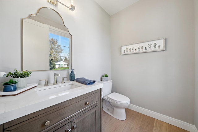 1663 Fairway Dr, Birmingham, MI 48009 - half bathroom featuring toilet, baseboards, vanity, and wood finished floors