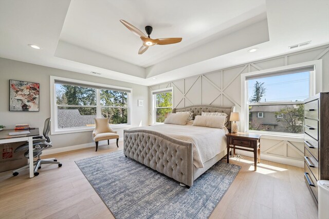 1663 Fairway Dr, Birmingham, MI 48009 - bedroom featuring light wood-type flooring, a tray ceiling, a desk, recessed lighting, and a ceiling fan