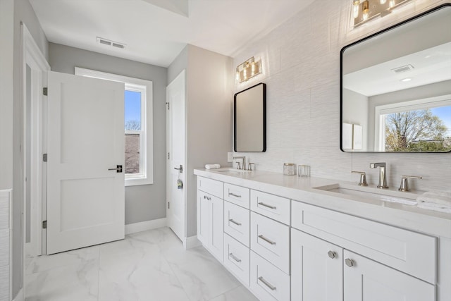 1663 Fairway Dr, Birmingham, MI 48009 - bathroom with double vanity, marble finish floors, tasteful backsplash, and baseboards