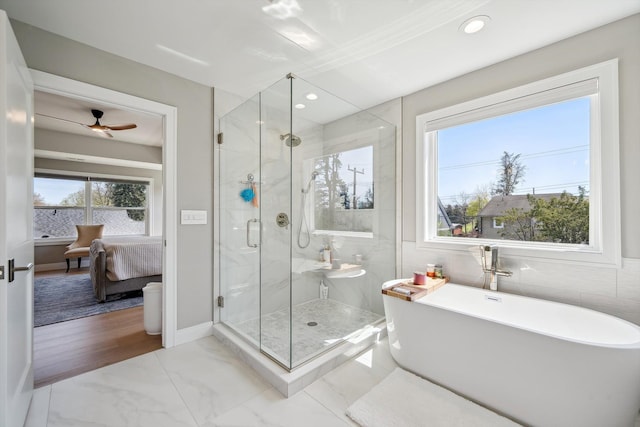 1663 Fairway Dr, Birmingham, MI 48009 - ensuite bathroom featuring a freestanding tub, a stall shower, marble look tiles, recessed lighting, and a ceiling fan