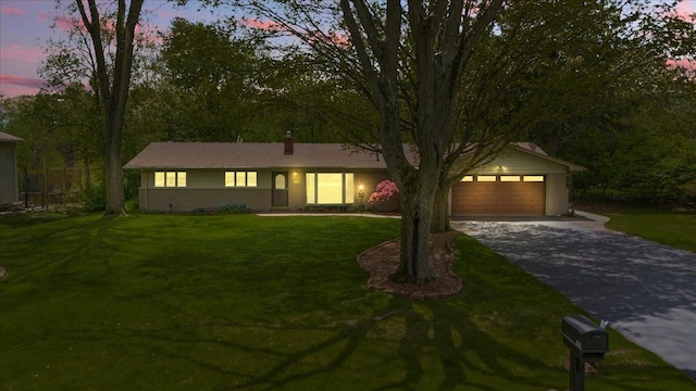 1831 Ansal Dr, Rochester Hills, MI 48309 - ranch-style house featuring driveway, a front lawn, and a garage