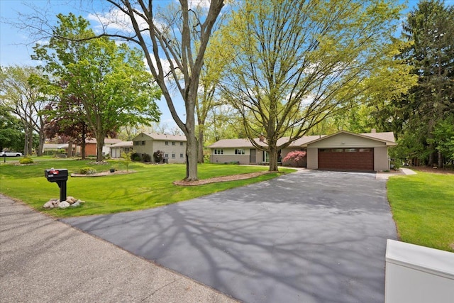 1831 Ansal Dr, Rochester Hills, MI 48309 - view of front facade featuring asphalt driveway, a garage, a front lawn, and a residential view