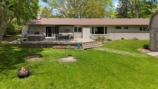1831 Ansal Dr, Rochester Hills, MI 48309 - back of property featuring a fire pit, a hot tub, a deck, a chimney, and a lawn