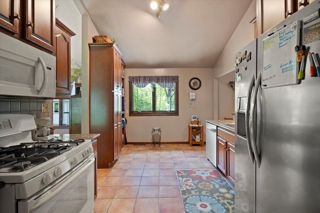 1831 Ansal Dr, Rochester Hills, MI 48309 - kitchen featuring stainless steel appliances, light tile patterned floors, lofted ceiling, and baseboards