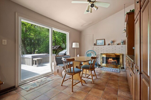 1831 Ansal Dr, Rochester Hills, MI 48309 - tiled dining space featuring a brick fireplace, lofted ceiling, and a ceiling fan