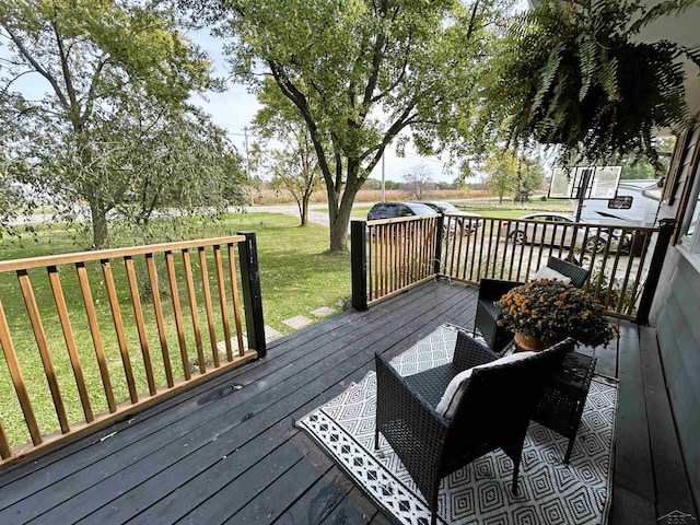 wooden deck featuring a yard