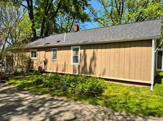 3188 Bessie St, Auburn Hills, MI 48326 - view of property exterior featuring a chimney, a shingled roof, and a yard