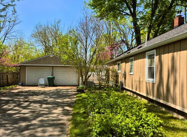 3188 Bessie St, Auburn Hills, MI 48326 - view of property exterior with a garage, an outdoor structure, fence, and a chimney