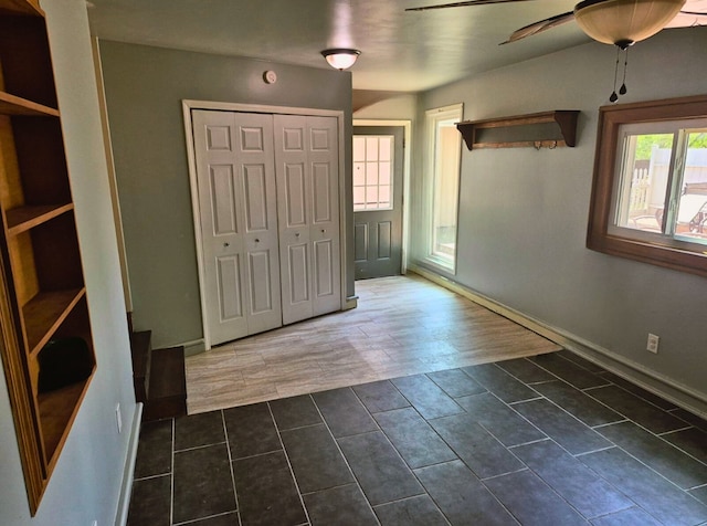 3188 Bessie St, Auburn Hills, MI 48326 - foyer entrance with a ceiling fan, dark tile patterned floors, and baseboards