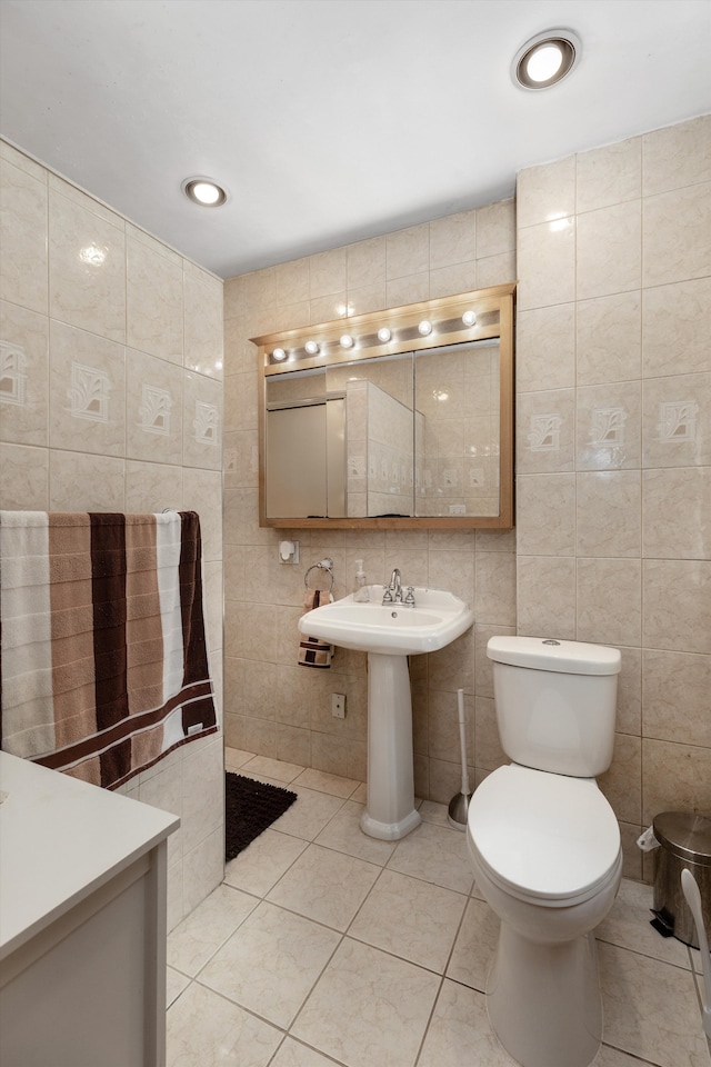 19319 Centralia, Redford, MI 48240 - bathroom featuring tile walls, tile patterned flooring, toilet, and a sink