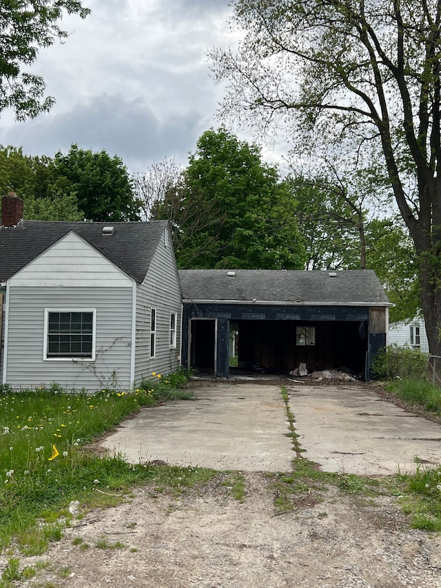 4073 Orgould St, Flint, MI 48504 - view of front facade featuring driveway, a shingled roof, and a carport