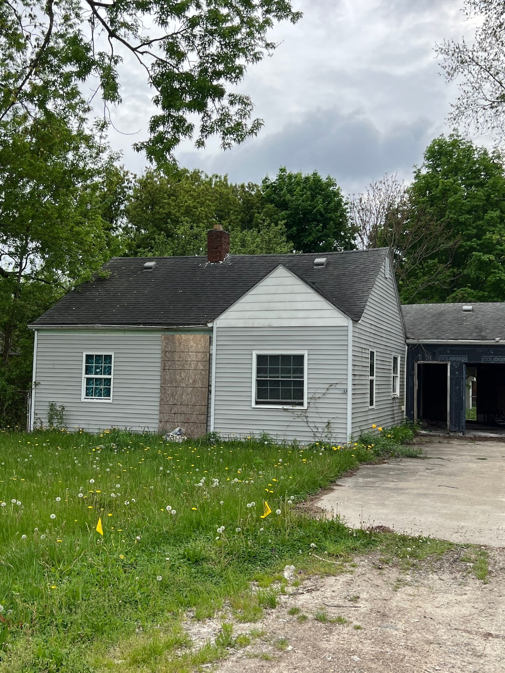 4073 Orgould St, Flint, MI 48504 - view of front of home featuring a chimney and a shingled roof