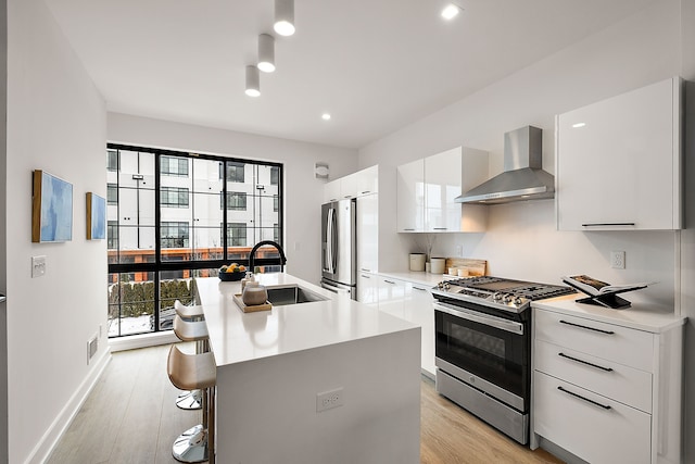 533 E Harrison Ave Unit 20, Royal Oak, MI 48067 - kitchen with stainless steel appliances, wall chimney exhaust hood, a sink, modern cabinets, and recessed lighting