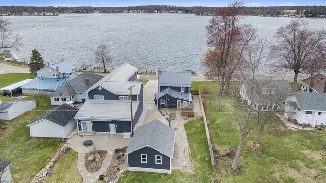 aerial perspective of suburban area featuring a nearby body of water