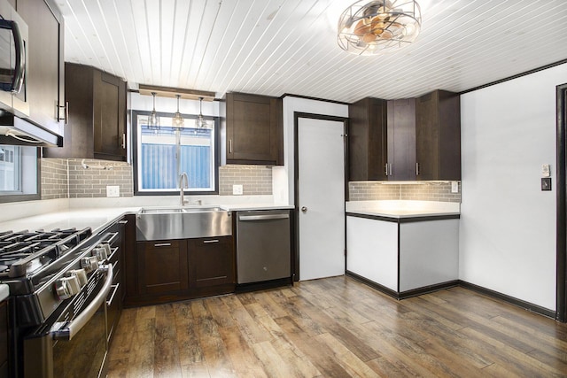 kitchen featuring dishwasher, a sink, gas range, dark brown cabinets, and light countertops