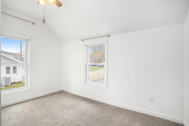 unfurnished room featuring vaulted ceiling, carpet flooring, baseboards, and ceiling fan