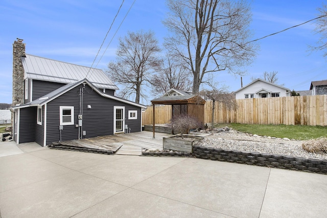 view of patio featuring fence and a wooden deck