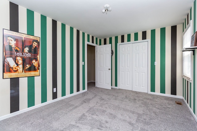 41944 Cherry Hill Rd, Novi, MI 48375 - unfurnished bedroom with carpet flooring, a closet, wallpapered walls, and baseboards
