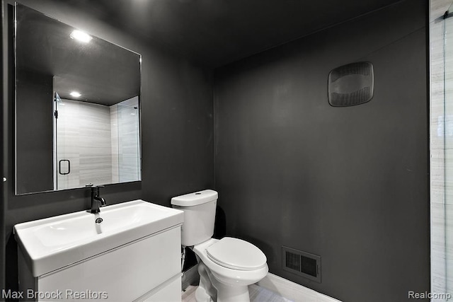 533 E Harrison Ave Unit 23, Royal Oak, MI 48067 - bathroom featuring toilet, vanity, a shower with door, and baseboards