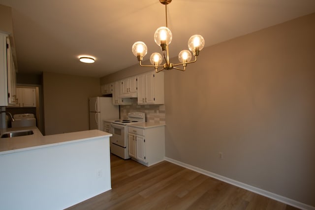 37374 Stonegate Cir, Clinton Township, MI 48036 - kitchen with white appliances, a sink, backsplash, and white cabinetry
